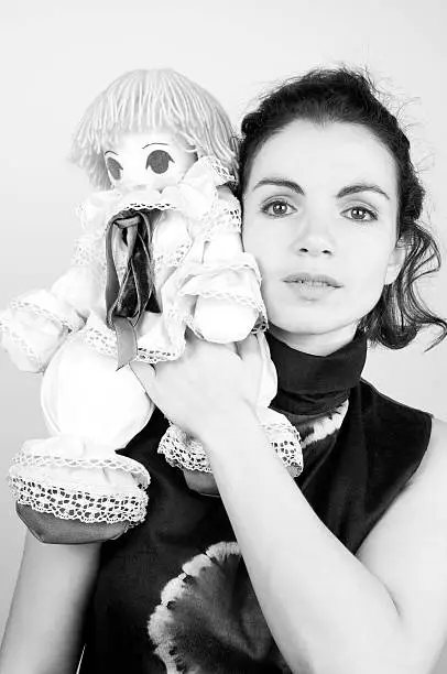 Photo of Serious Woman with Rag Doll in B&W