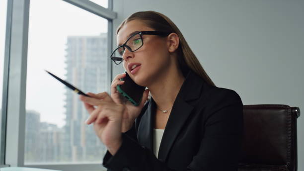 istock Professional manager speaking phone with client closeup. Focused office woman 1597516093