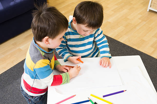 istock Twin boys drawing at a table together 159754578