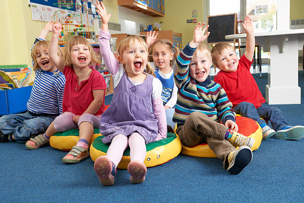 istock Group Of Pre School Children Answering Question In Classroom 159757214