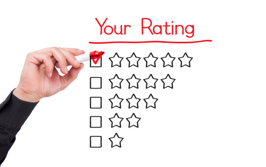 Businessman Writing Red Mark on Five Star Choice on Rating Survey Form