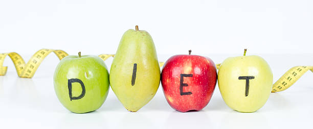 istock Dieting Concept Fruit with Measuring Tape on White Background 159757459