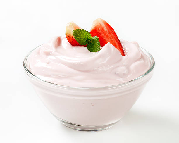 Strawberry dessert in a clear bowl white cream with strawberries and mint in a small glass bowl yoghurt stock pictures, royalty-free photos & images