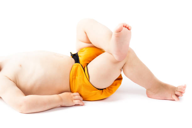 Baby lying relaxed on his back with cloth diaper stock photo