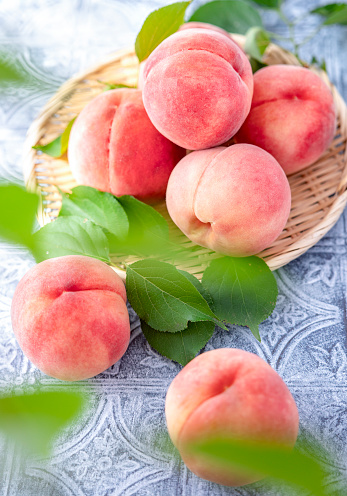 Whole Japanese Peaches on Zaru Basket