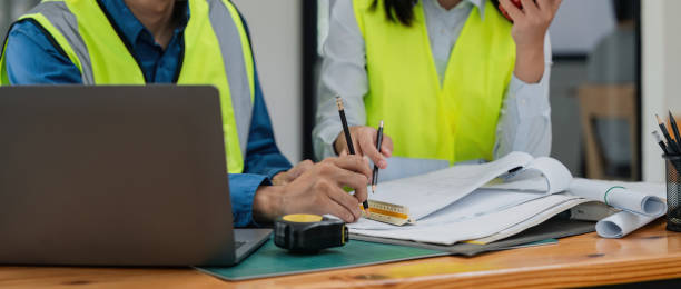 istock Two engineer working in office with blueprints, inspection in workplace for architectural plan, construction project ,Business construction 1597606750