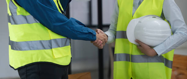 istock Close up team young engineer handshake with partnership, customer after agreement to work together at the site, workplace, office. Business success concept 1597608299