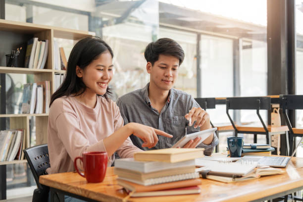 istock Male and female students reading a book. library research, reading and students with a book, learning knowledge at college. Scholarship, smile at university for education 1597628101