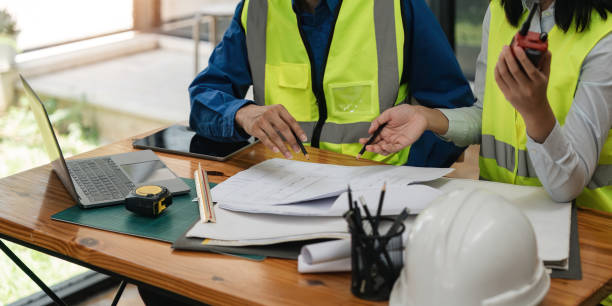 istock Two engineer working in office with blueprints, inspection in workplace for architectural plan, construction project ,Business construction 1597660475