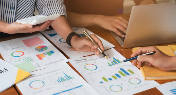 istock Business team analyzes financial business finance reports on laptop and graph documents during corporate meeting discussions showing successful teamwork, business meeting ideas 1597669357