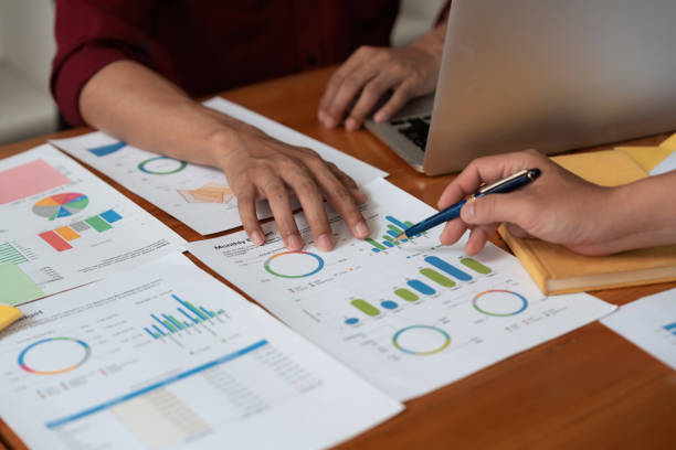 istock Business team analyzes financial business finance reports on laptop and graph documents during corporate meeting discussions showing successful teamwork, business meeting ideas 1597669796