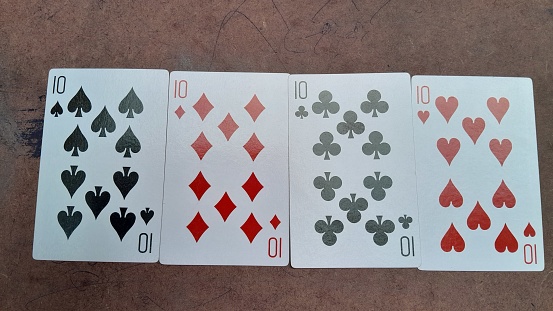 Hand with poker cards isolated on dark background