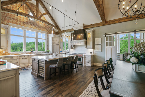 Dark hardwood flooring with beautiful decorative wood beams on the ceiling of the kitchen area