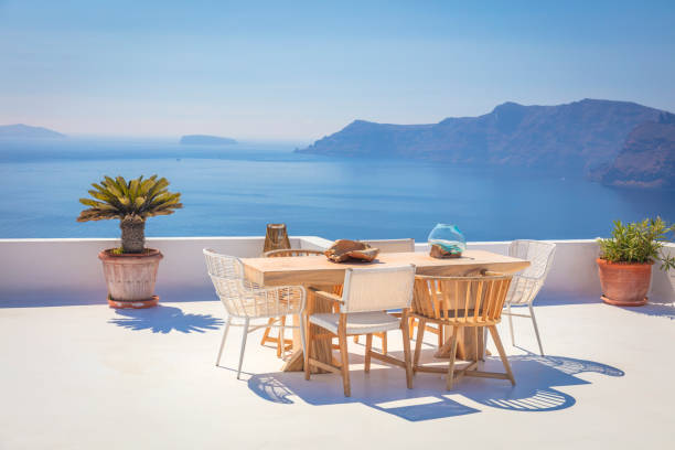 istock Santorini for relaxation. Greece, Santorini island, Oia - white architecture and deep blue. Table and chairs on the terrace. Greek Islands, Santorini 1597751964