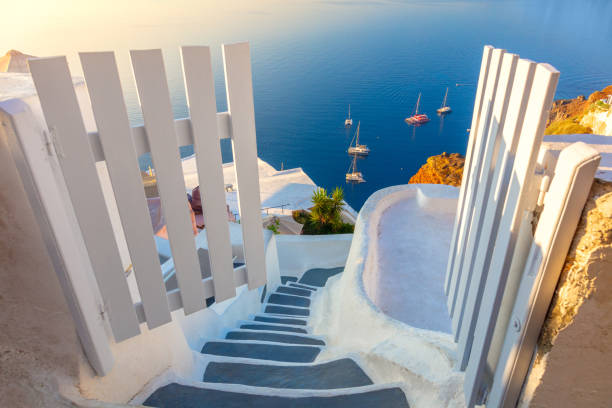 istock Amazing Gate to heaven. Santorini, Greece. White architecture, open doors and steps to the blue sea of Santorini. 1597751965