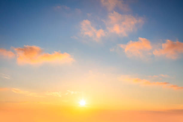 istock Light Pastel cloudscape. Sunrise sundown sky with gentle colorful clouds without any birds. With sun. 1597751986