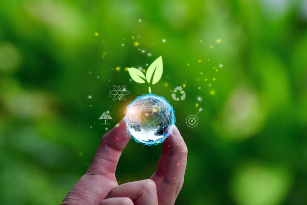 istock Earth glass globe ball and tree icon in hand saving the environment, 1597763494