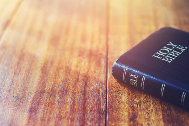 istock holy bible on wooden table background with soft morning sun light with copy space 1597787294