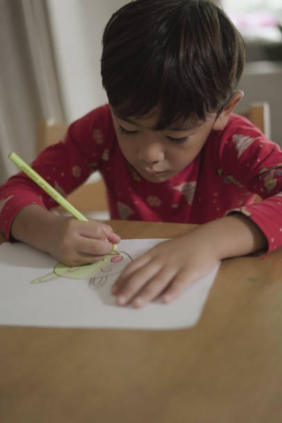 istock Boy drawing and coloring on the table 1597789784