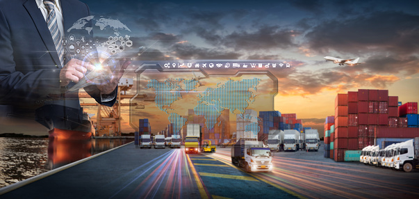 Multiple exposures of Businessman touching tablet for analyze stock at logistics port and world map with logistic network distribution on background, transportation trading business concept