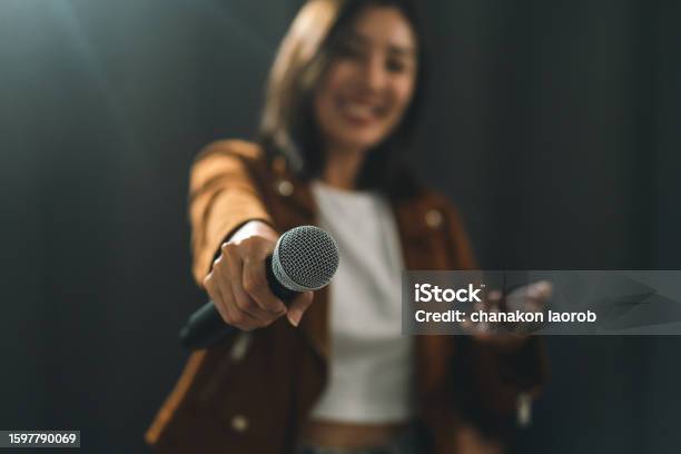 Close Up Woman Hand Holding High Quality Dynamic Microphone And Singing Song Or Speaking Talking With People On Isolated White Background Woman Testing Microphone Voice For Interview Stock Photo - Download Image Now