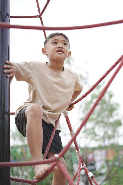 istock Boy climbing rope equipment 1597790174
