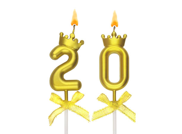 istock Gold birthday candles burning on white, number 20. 1597791175