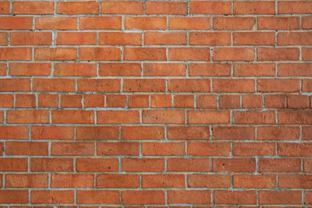 istock Red brick wall background in rural room. 1597822599