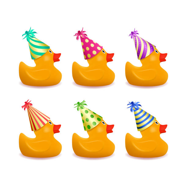 желтая резиновая утка в цветных праздничных шляпах - rubber duck stock illustrations
