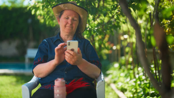 istock Senior woman taking break from gardening and resting 1597838926