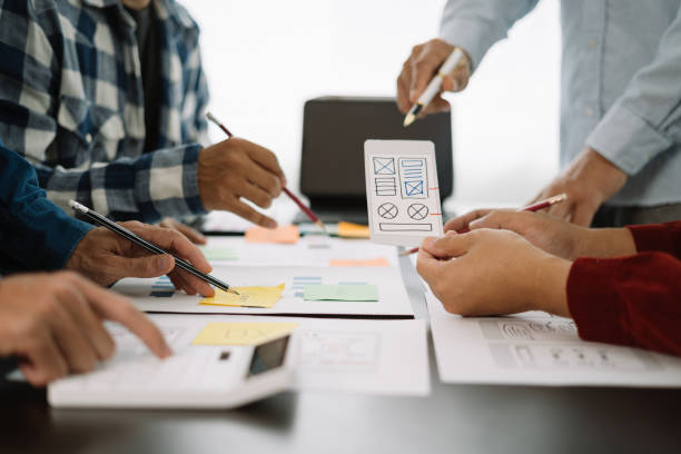 istock ui designer brainstorming about mobile app interface wireframe design with customer breif and color code at office. 1597856928