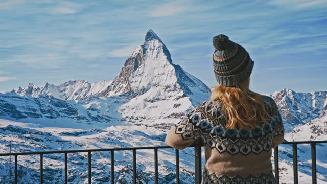 WS A fashionable woman enjoys the view of the mighty Matterhorn mountain