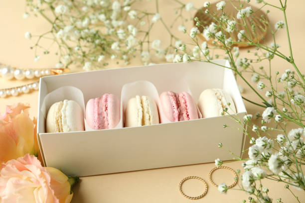 istock Female accessories and macaroons on beige background 1597871861