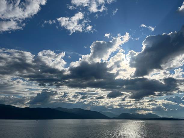 istock Backlit white clouds in blue skies over Glacier Bay, Alaska. 1597892180
