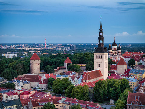 Tallinn Toompea Hill Estonia Old Town Aerial Cityscape in Summer. Shot during the white nights of Midsummer in Estonia at Sunrise. Aerial view over the Old Town on Toompea Hill with Saint Nicholas Church, St. Alexander Nevski Cathedral (in the background) and surrounding Toompea Hill city fortified walls and old town buildings. Tallinn, Toompea Hill, Old Town Tallinn, Estonia, Northern Europe