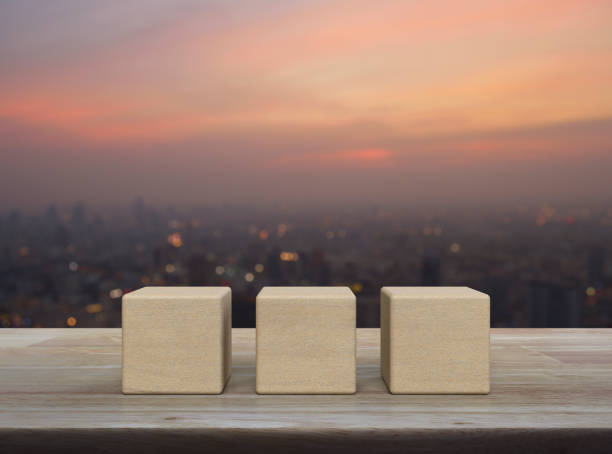 istock Three wood block cubes on wooden table 1597910175