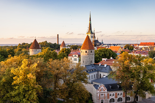 Tallinn Estonia Old Town Toompea Hill Cityscape in Summer in Sunset Twilight. View over the Old Town of Tallinn, Toompea Hill with Saint Nicholas Church in the background and surrounding Toompea Hill City Fortified Walls, Medieval Towers and Old Town Buildings. Tallinn, Toompea Hill, Old Town Tallinn, Estonia, Northern Europe