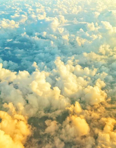 istock Dawn seen from an airplane flying over the clouds. 1597952057
