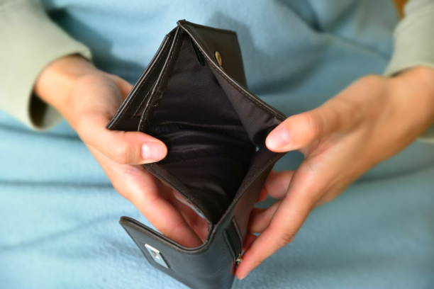 istock a woman with an empty purse 1597955881