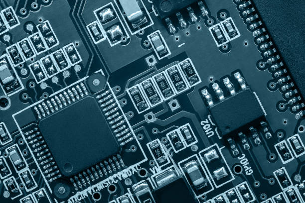 istock Closeup of Printed Circuit Board with processor, integrated circuits and many other surface mounted passive electrical components. 1597964901