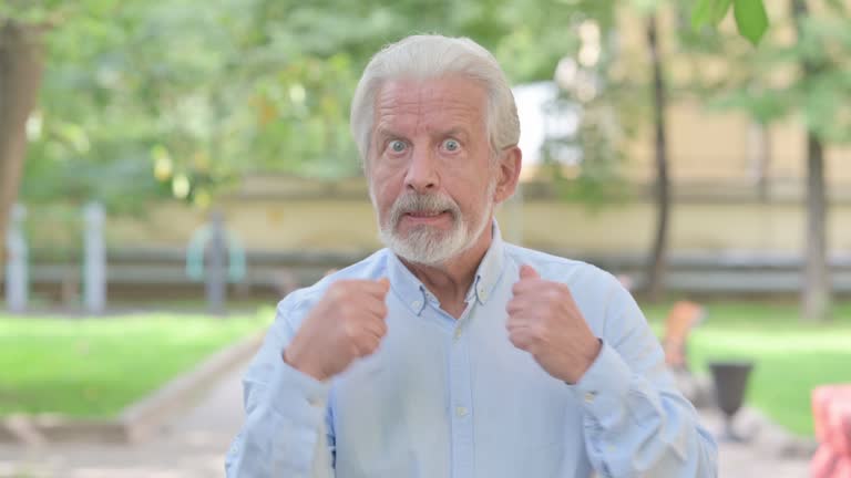 Outdoor Portrait of Angry Senior Old Man Arguing and Fighting