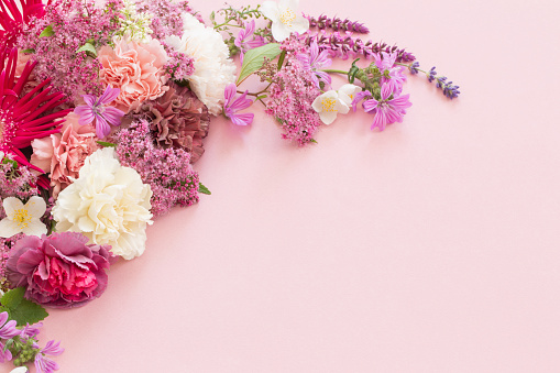 istock beautiful summer flowers on pink paper background 1598031976
