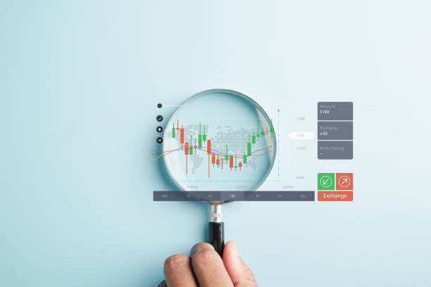 istock Magnifier glass focuses on the bar graph with an increasing arrow 1598041141