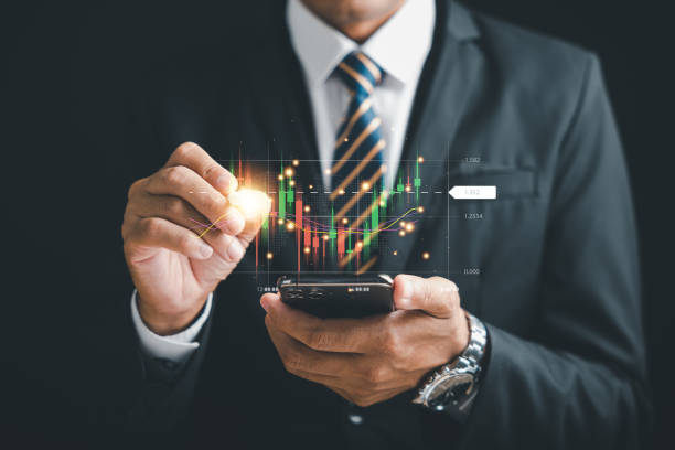 istock Successful trader using smartphone for online stock trading 1598041727