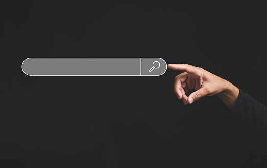 Finger touches the button of a blank search bar on a business web banner promoting the concept of search engine optimization black background. digital screen importance of SEO in the world technology