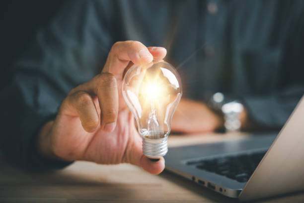 istock Businessman protects a glowing light bulb, symbolizing creativity and innovation 1598045074