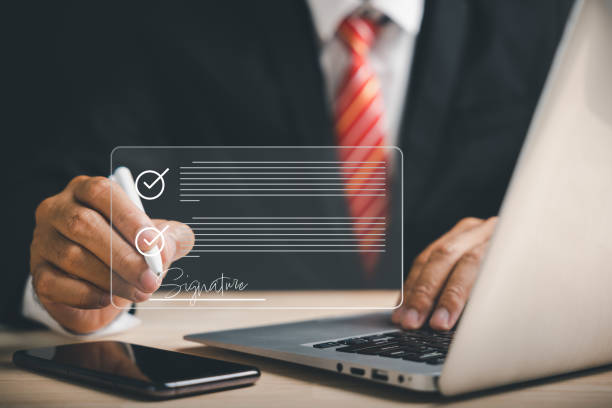 istock Efficient document management Businessman uses pen to sign electronic documents on virtual screen 1598045110
