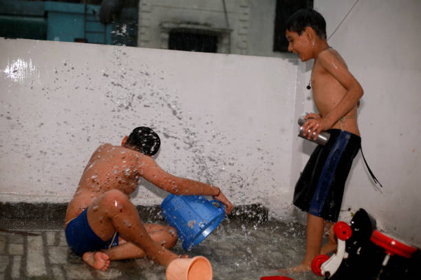 istock Playful children enjoying rain at home 1598045130