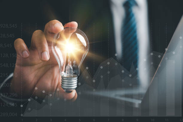 istock Businessman protects a glowing light bulb, symbolizing creativity and innovation 1598045131