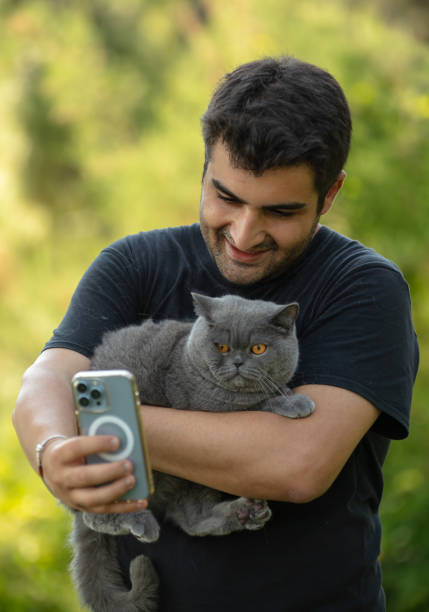istock Young handsome man is taking a selfie with his cat. 1598056536